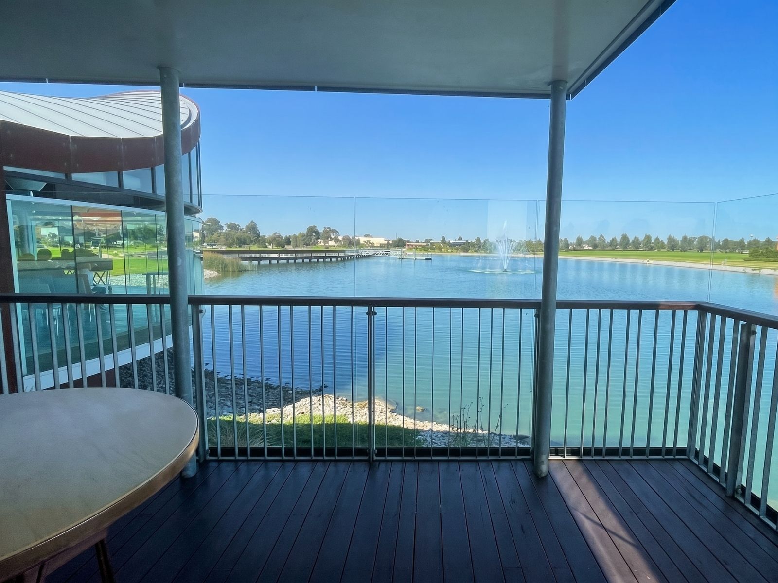 overed balcony at Sanctuary Chapel, Bunurong Memorial Park, looking across the lake to the fountain and boardwalk