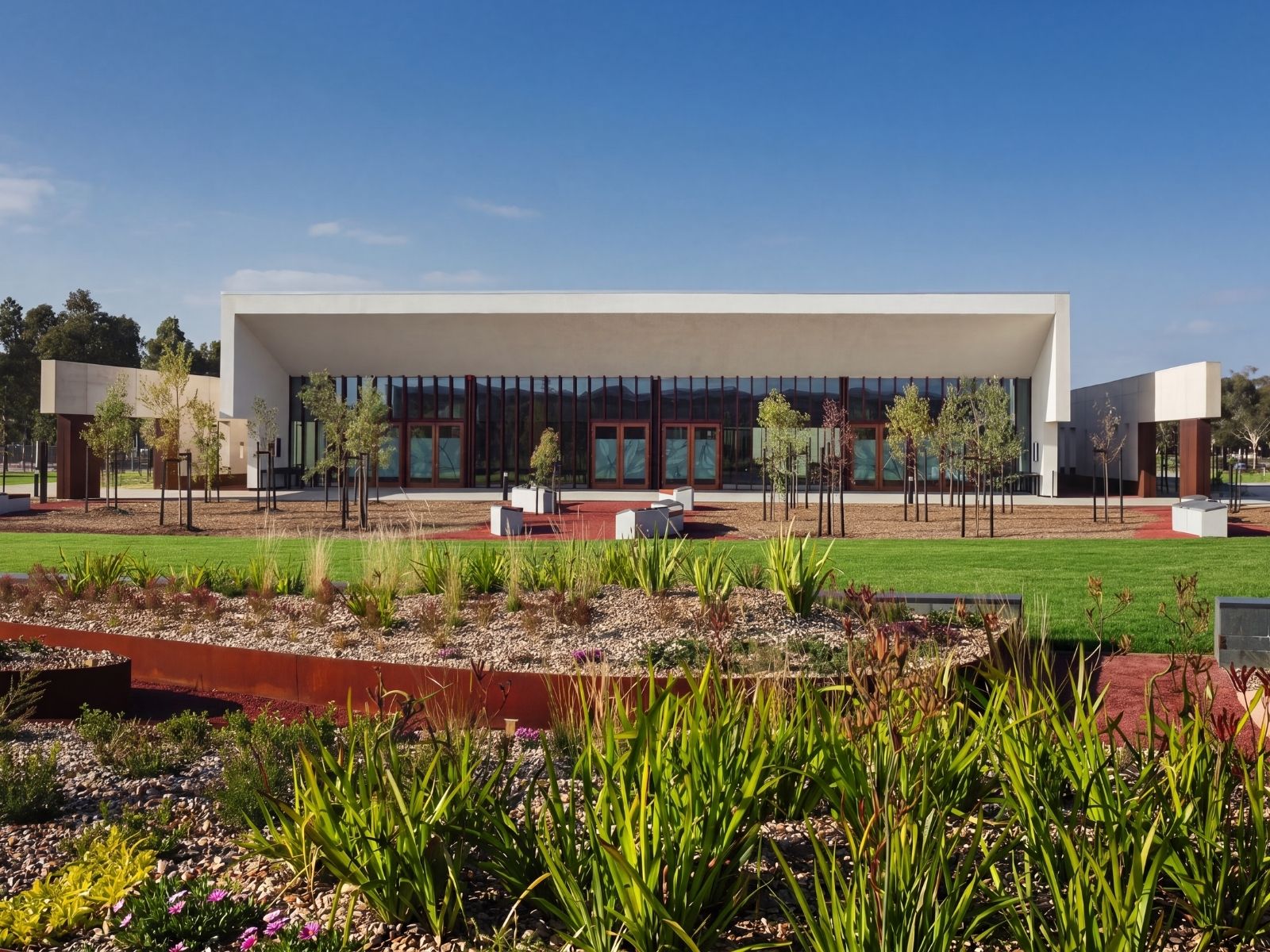 Full facade of the combined Cumulus and Stratus chapels at Bunurong Memorial Park, with both entry portals and native gardens