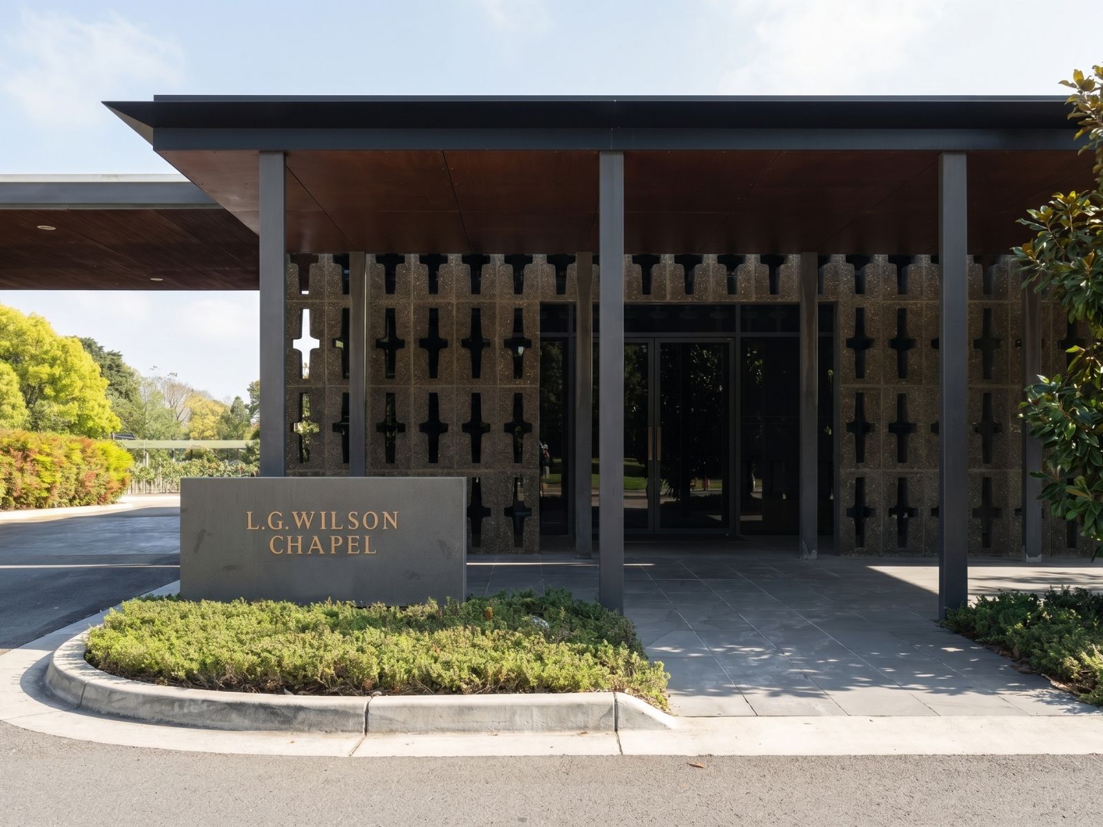 Wilson Chapel exterior at Springvale, modernist pavilion with cross-patterned walls and chapel name stone