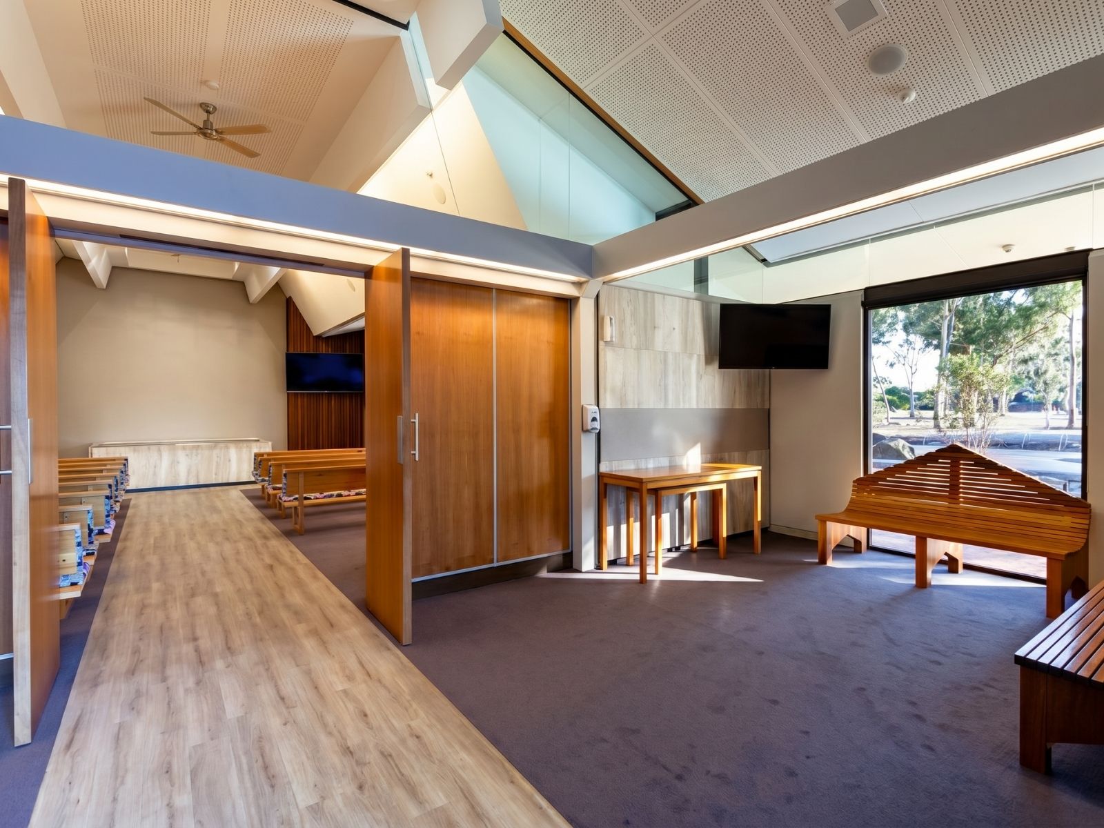 Crick Chapel foyer at Fawkner with operable timber walls opening to the chapel and garden views