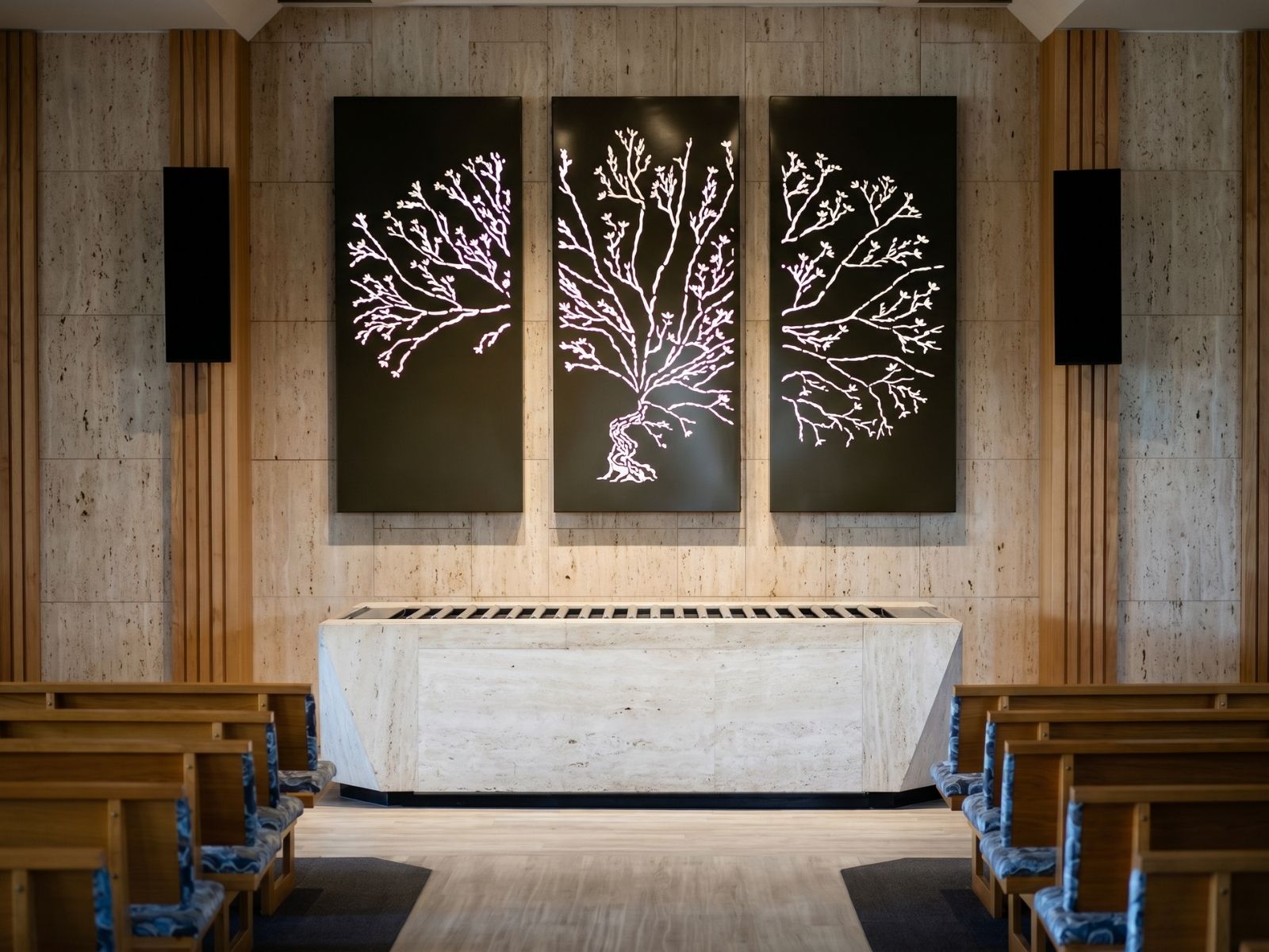Illuminated blossom tree artwork above the stone catafalque inside Cordell Chapel at Fawkner