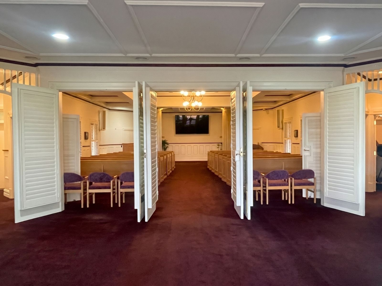 White louvred doors opening between rooms inside Federation Chapel at Lilydale