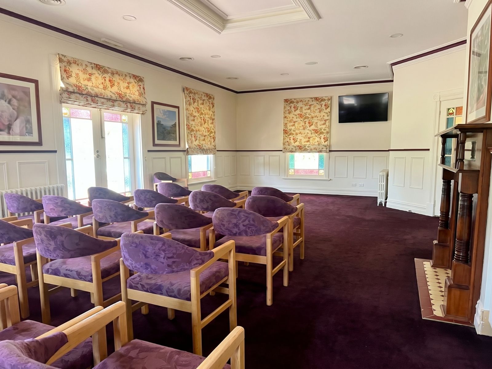 Overflow room at Federation Chapel with armchair seating, floral blinds and heritage panelling