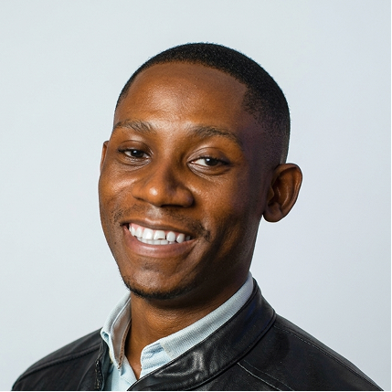 Splendour Austin owner of Bigsite web design agency with short hair wearing a black jacket and white collared shirt.
