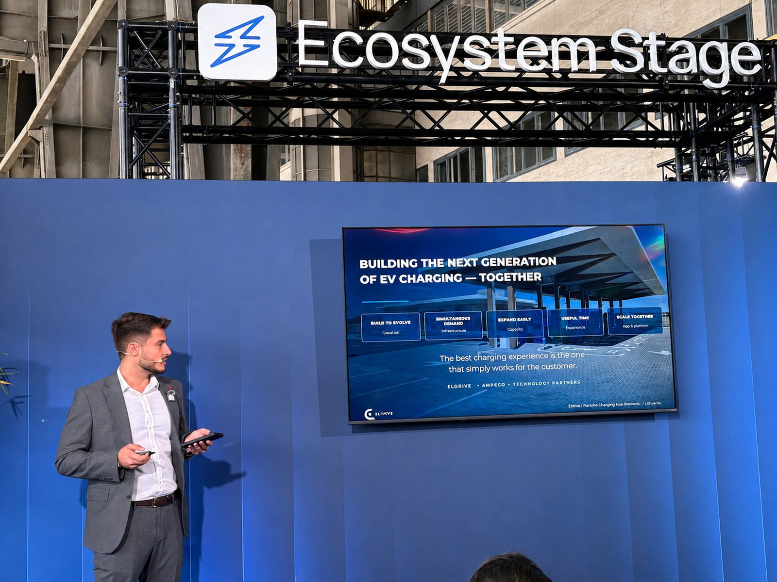 Dragoș Teodorescu on the Ecosystem Stage at icnc26 beside the closing slide of the Eldrive keynote