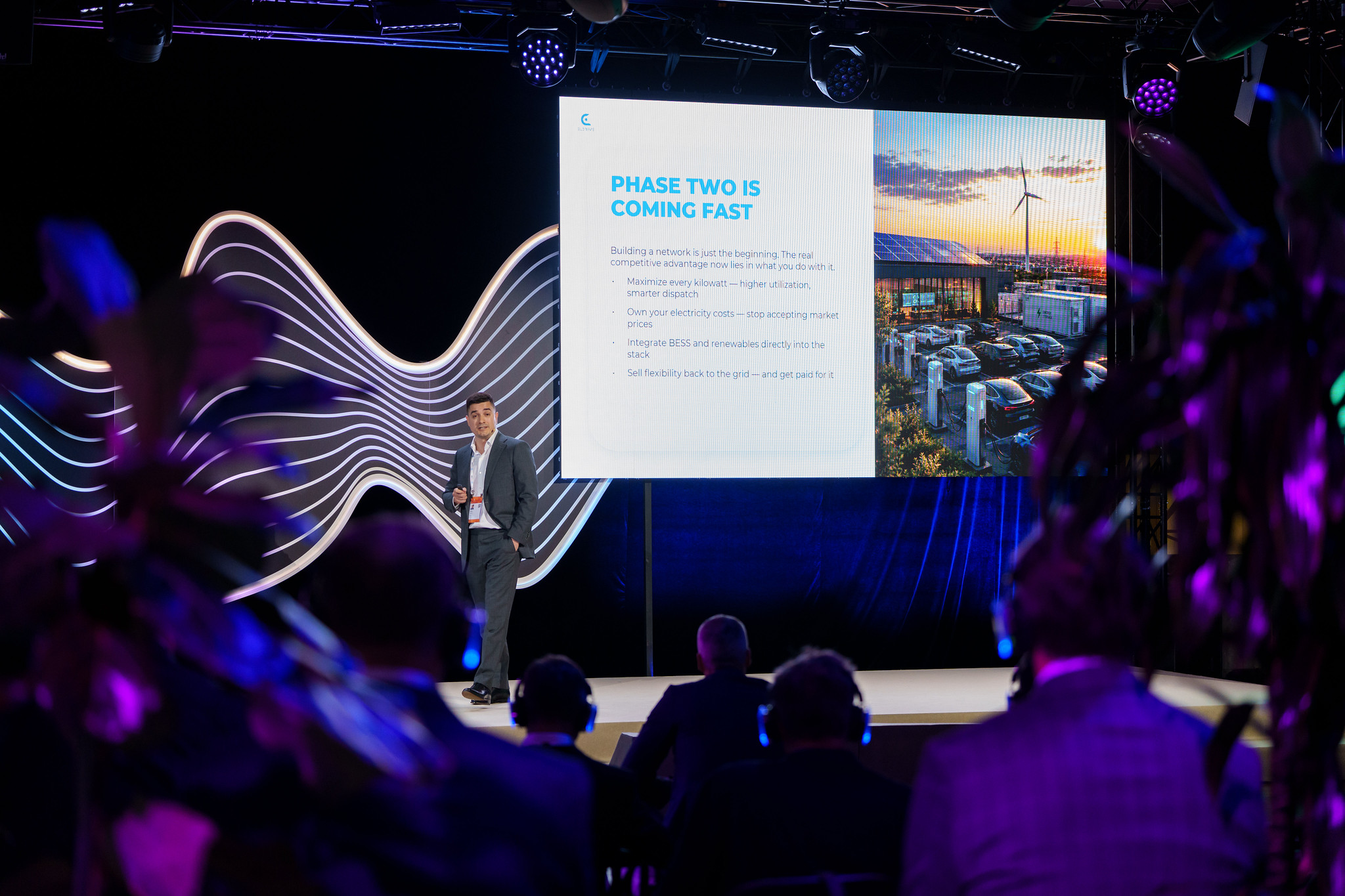 Stefan Spassov on stage in Riga with the slide 'Phase two is coming fast'