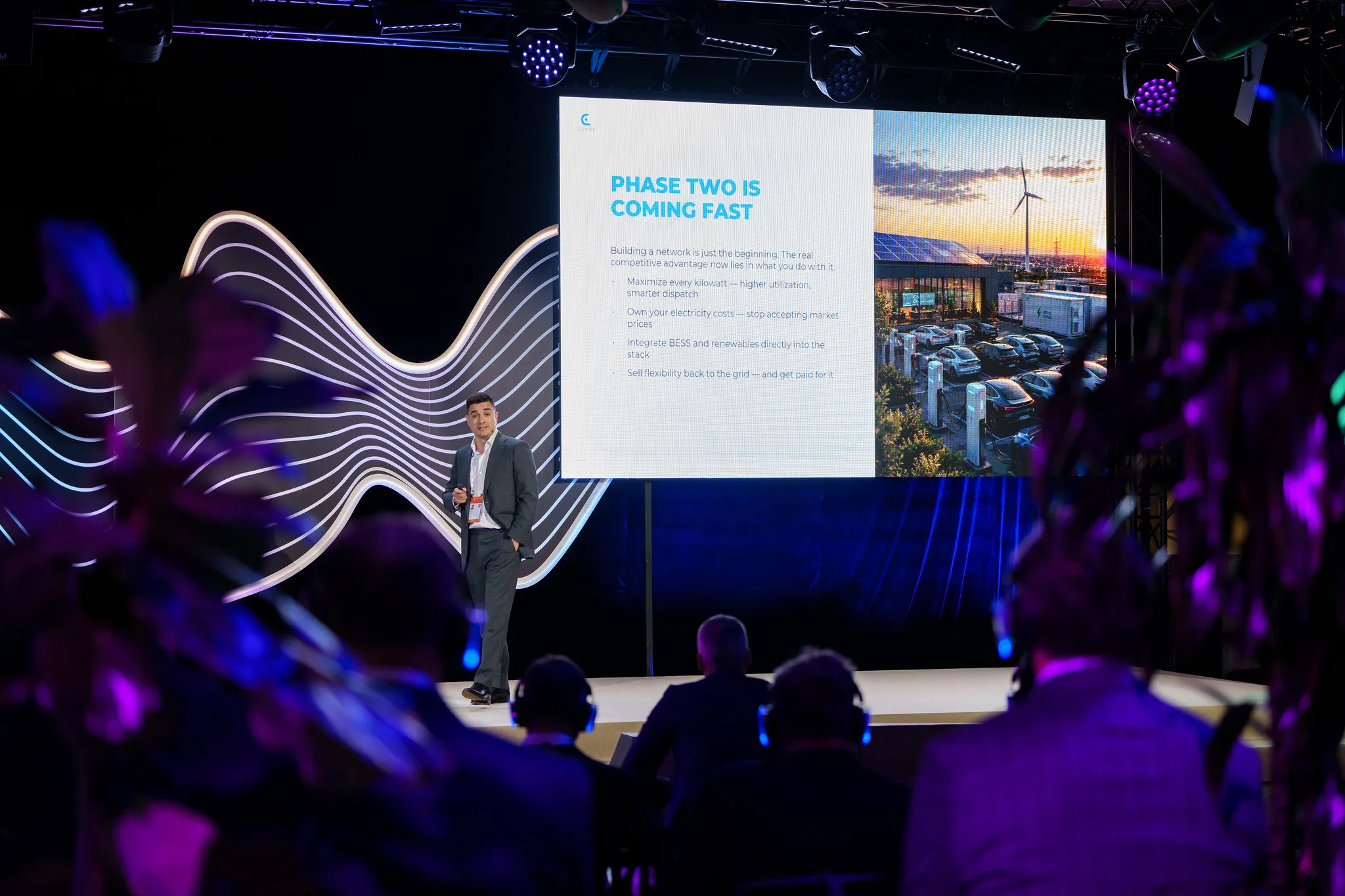 Stefan Spassov on stage in Riga with the slide 'Phase two is coming fast'