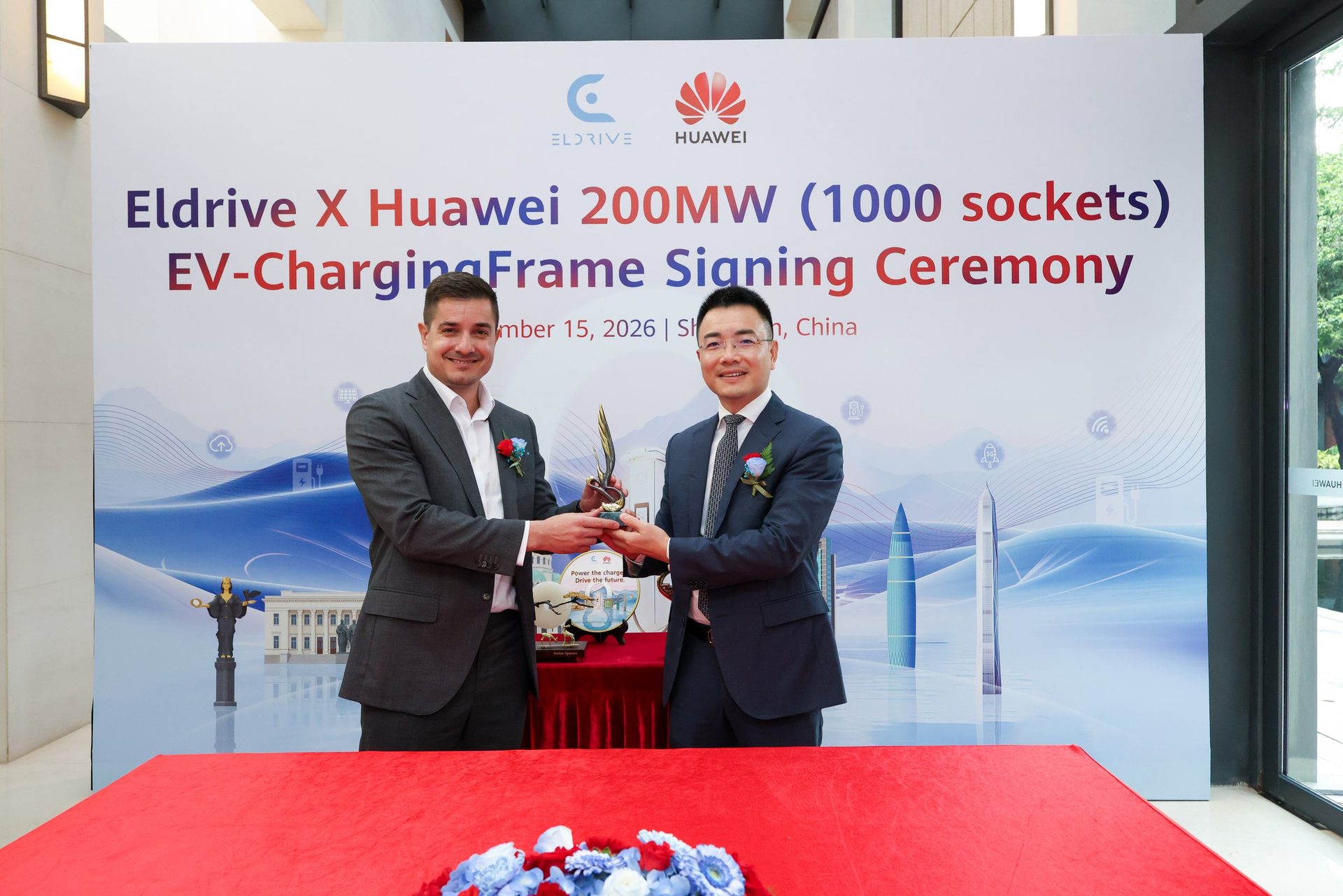 Stefan Spassov, CEO of Eldrive, and a Huawei representative exchange gifts after the signing in Shenzhen