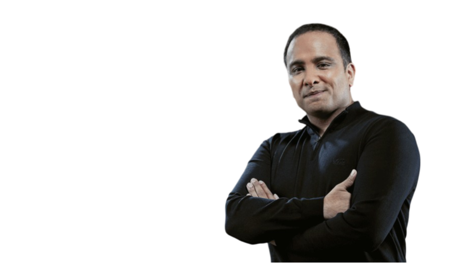 Man with folded arms wearing a black long-sleeve shirt looking confidently at the camera.