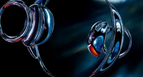 Shiny silver metallic spirals with reflective blue and red highlights on a dark background.