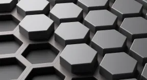 Dark gray hexagonal tiles arranged in a staggered pattern with some gaps between them.