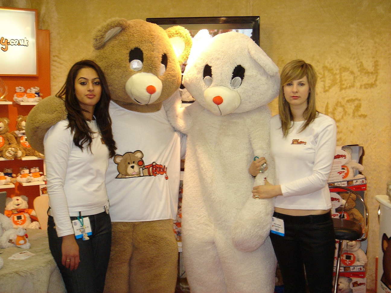 iTeddy mascot and Easter Bunny posing with team members at the iTeddy toy fair.