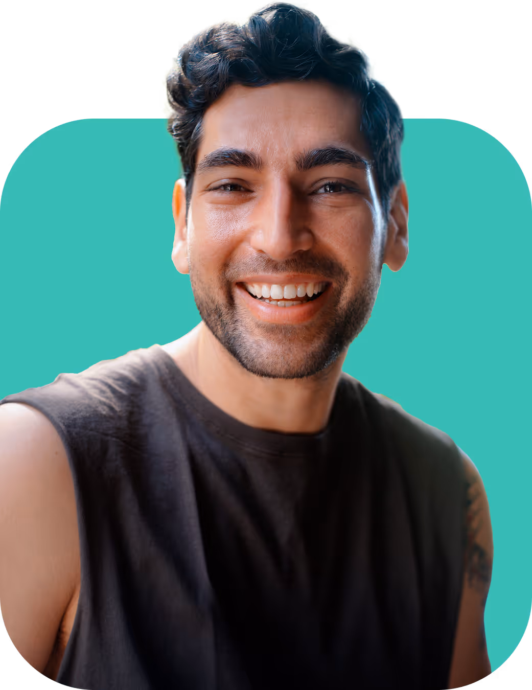 Smiling man with dark curly hair, beard, and a sleeveless black shirt on a teal background.