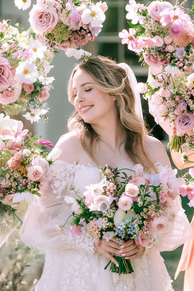 Bride surrounded with bridal boquets at Preswald Hall
