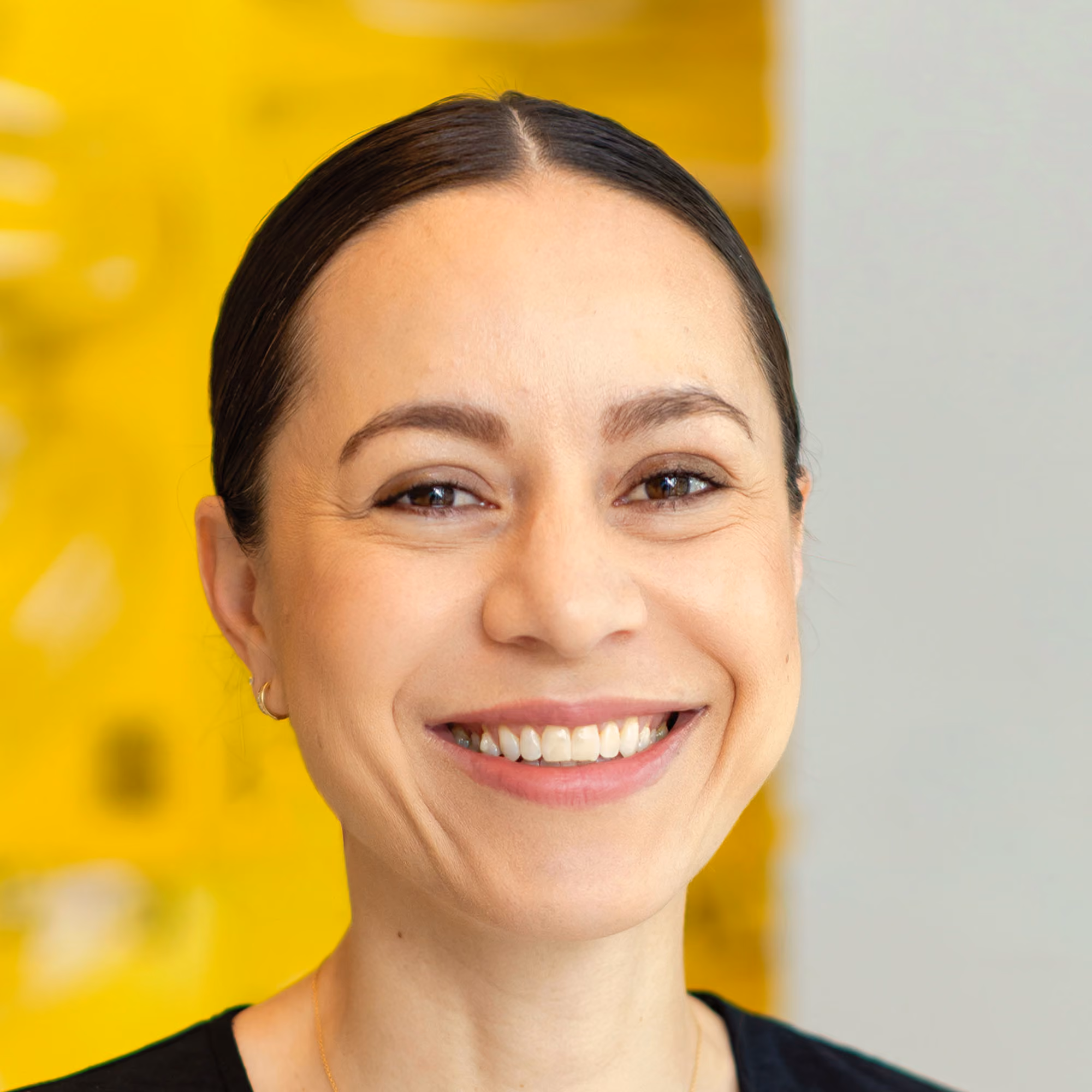 Professional headshot of Amelia Bauerly, a Senior Product Designer at GitLab, smiling confidently with a neutral background.