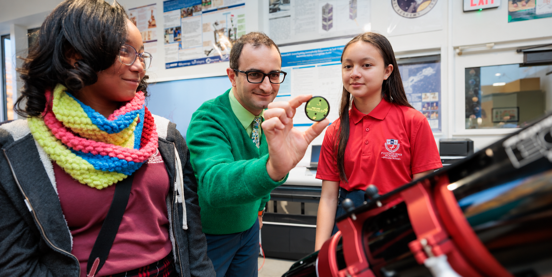 An FSA teacher exploring science with two students