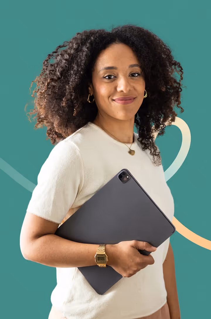 Smiling woman with curly hair holding a tablet against a teal background with abstract lines.