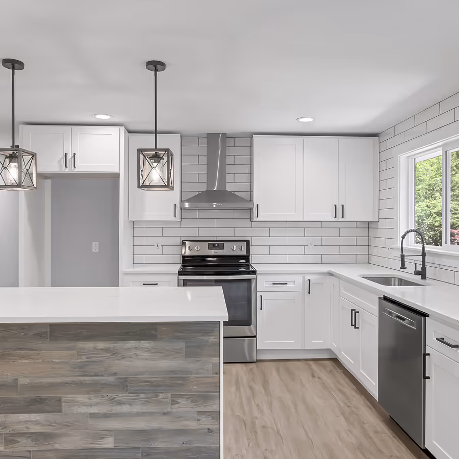 Bright white kitchen with shaker cabinets, subway tile backsplash, stainless steel appliances, and a rustic wood-plank island front.