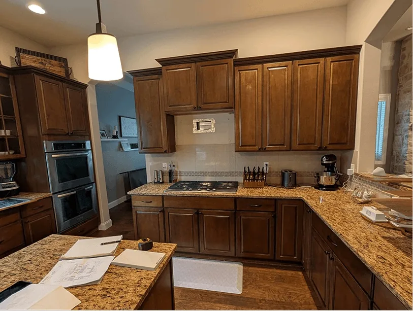 Before: Bonney Lake kitchen range wall with a cooktop, wall ovens and dark cabinets