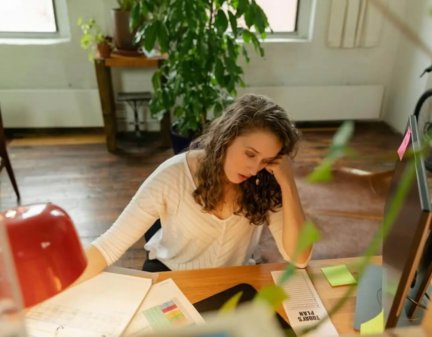 A woman sitting at a desk with a computer.
