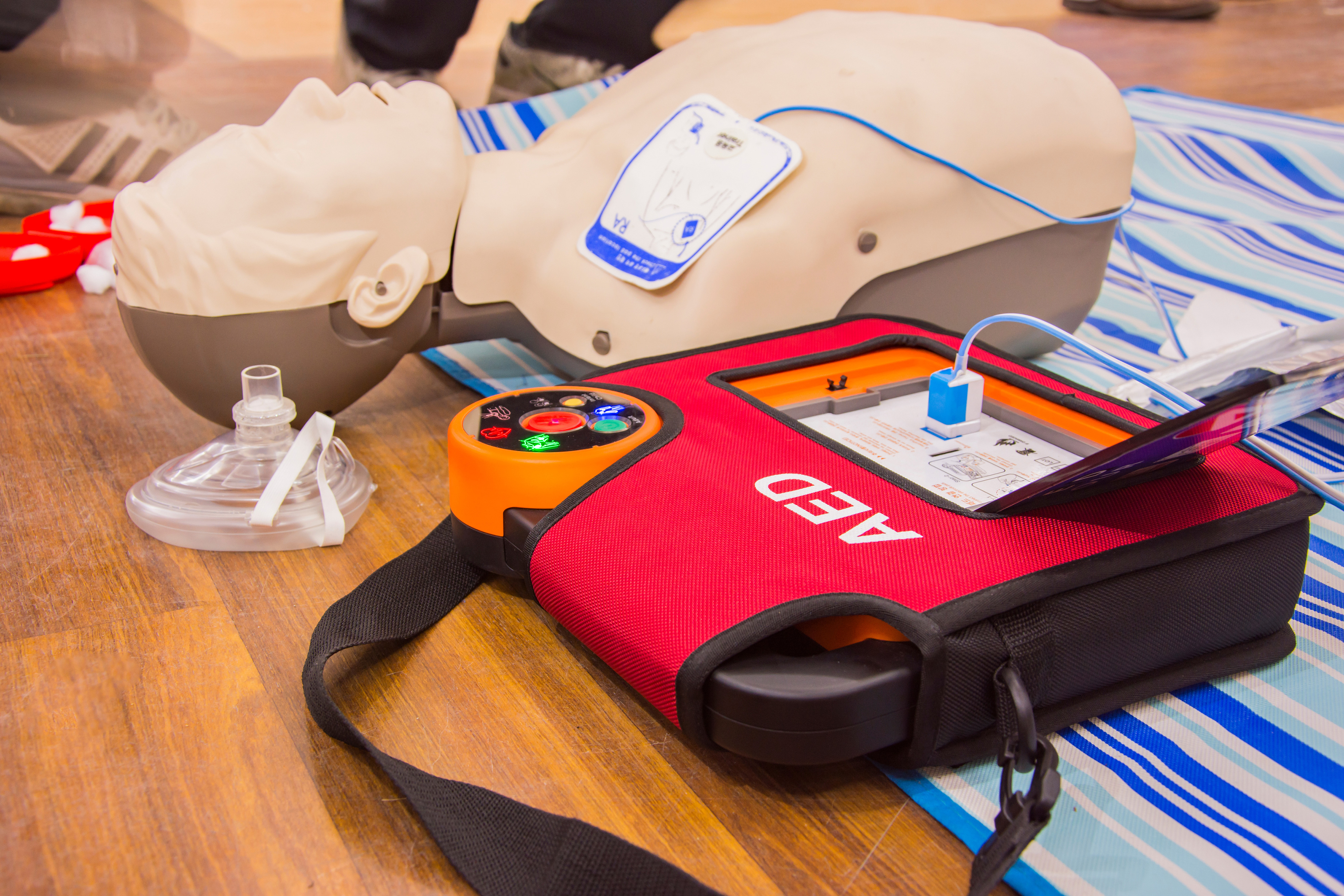 Two participants practicing CPR with a training manikin