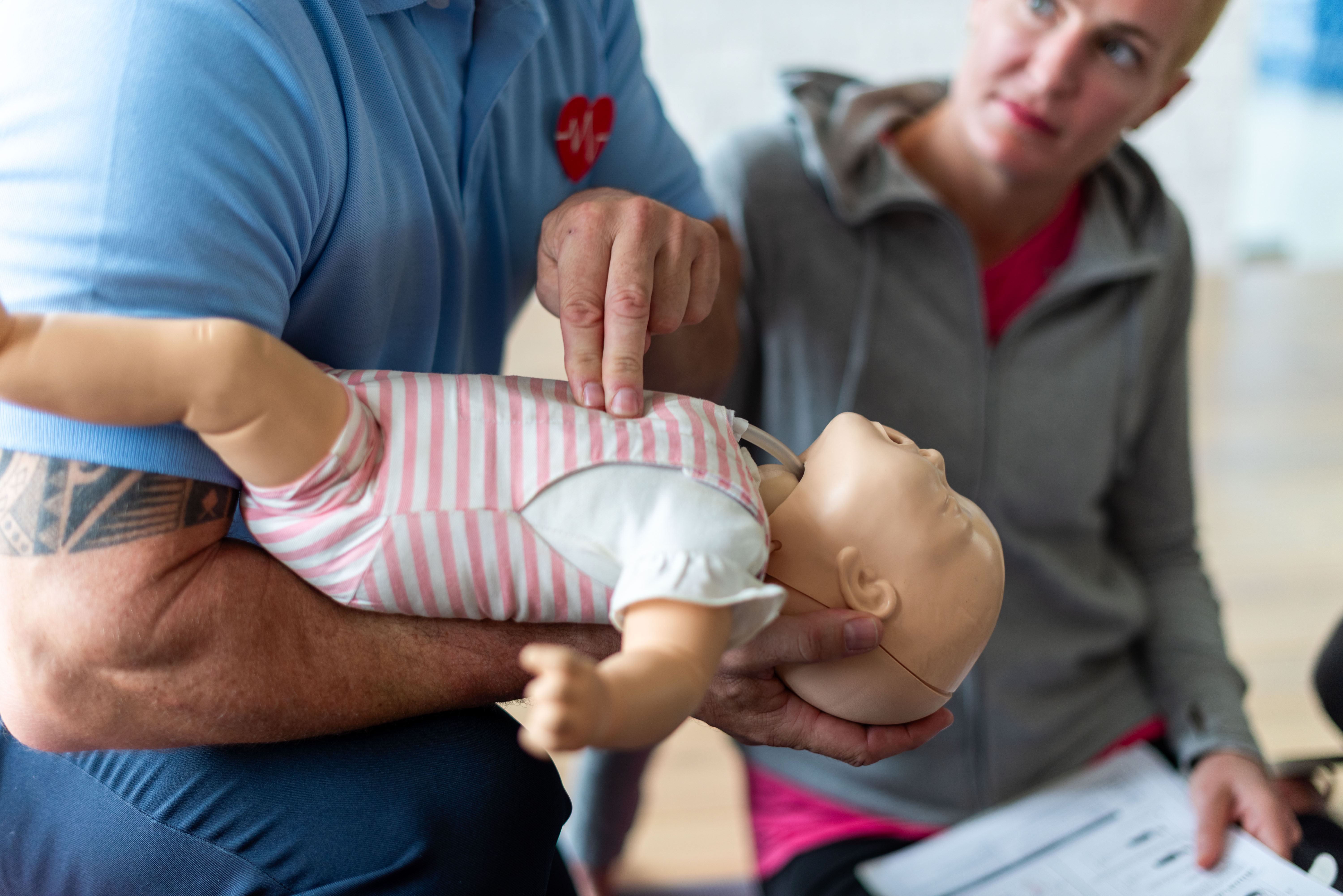Participants practicing CPR with training manikins during a class