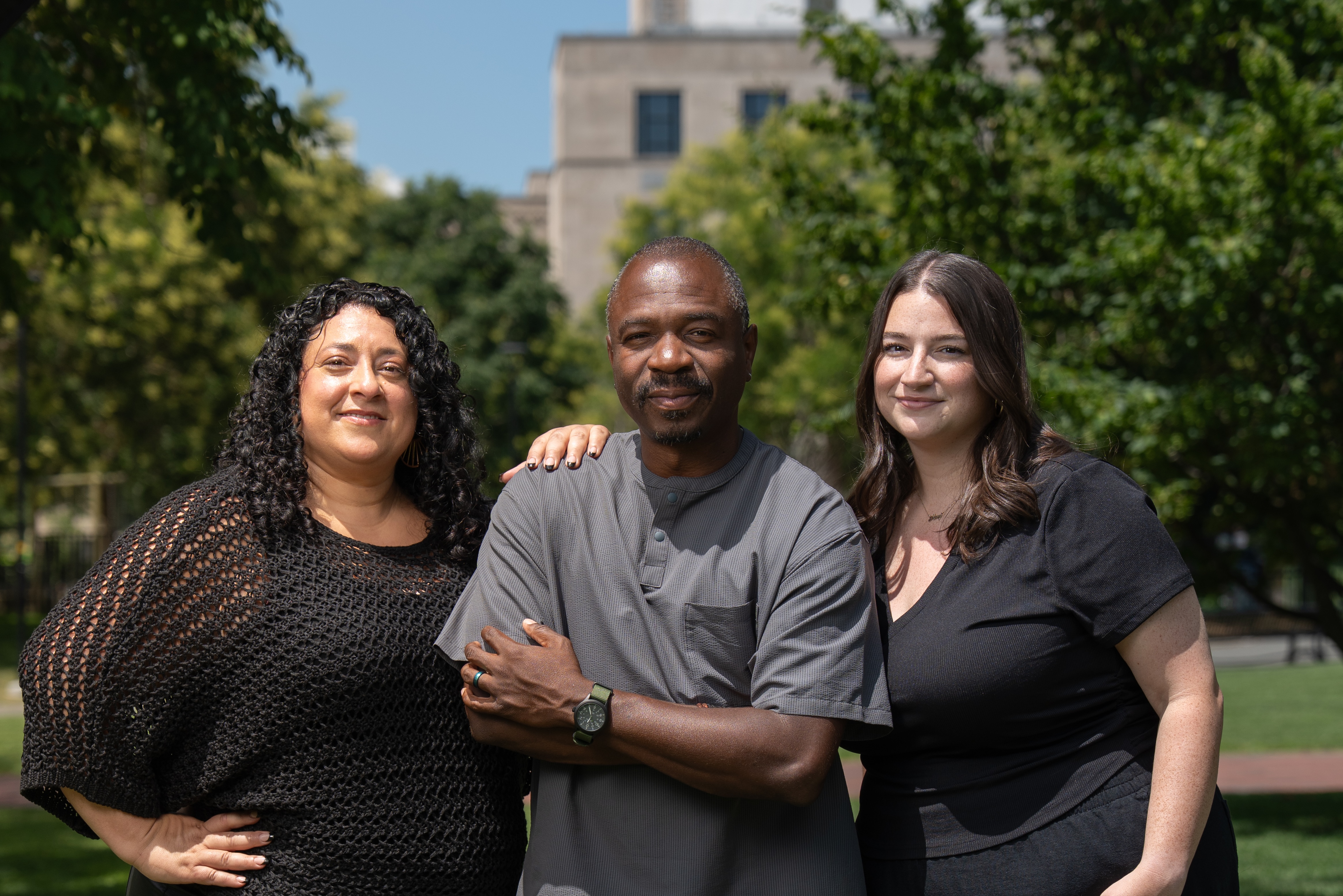 Liz, Thabiti, and Amy posing in greenery