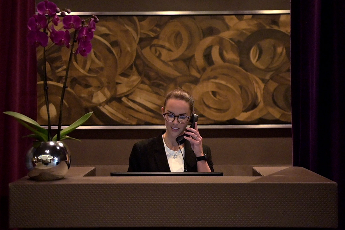 Front of house receptionist on phone