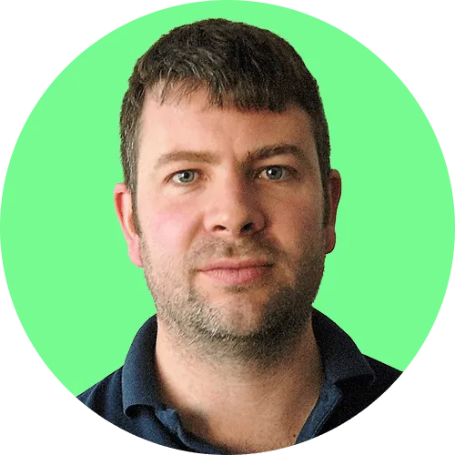 Portrait of a man with short brown hair and light beard against a bright green circular background.