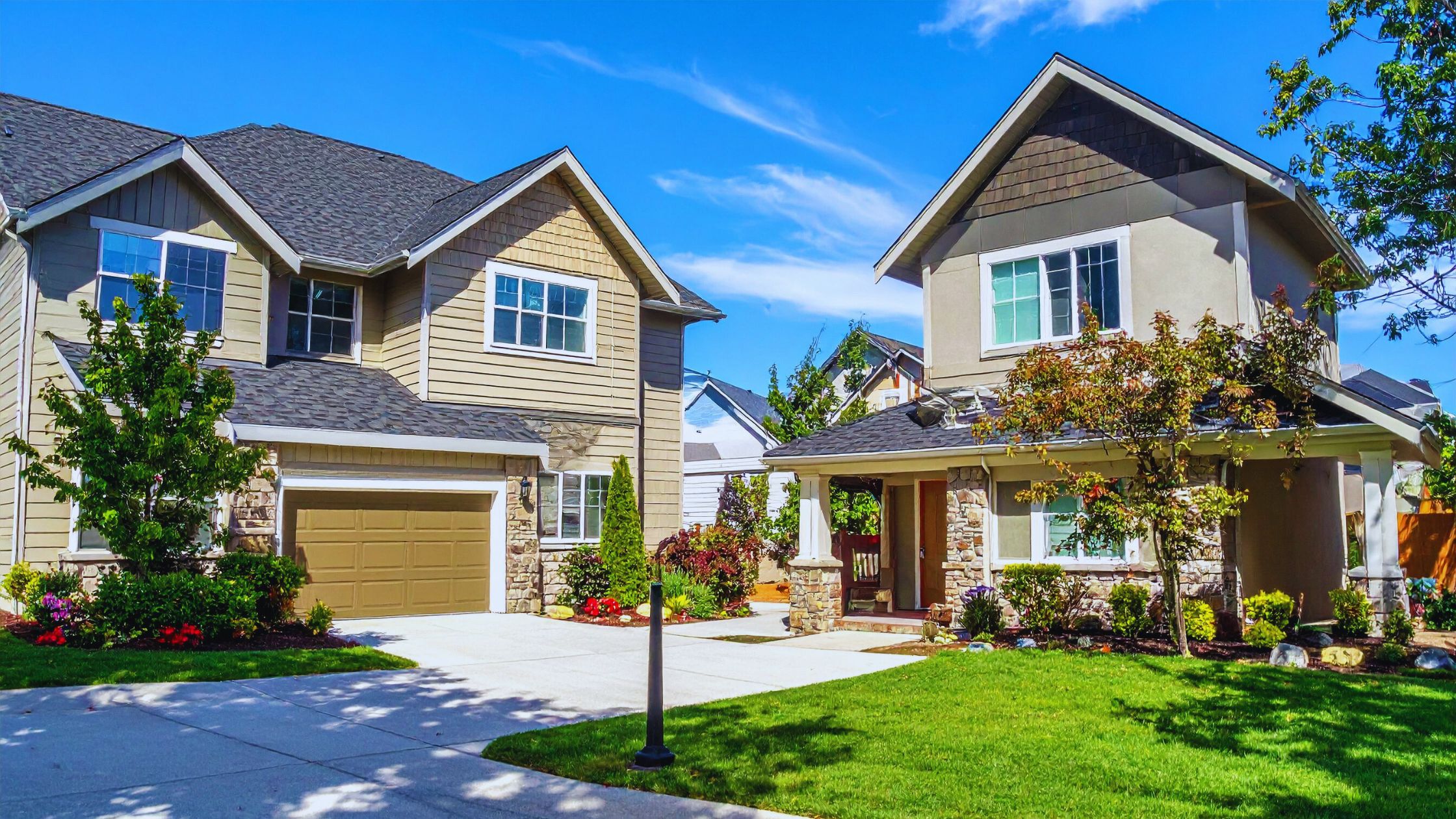 "A modern suburban home with a spacious driveway and double garage, set against a vibrant sunset sky, featuring well-maintained landscaping and a cozy porch light illuminating the entryway.