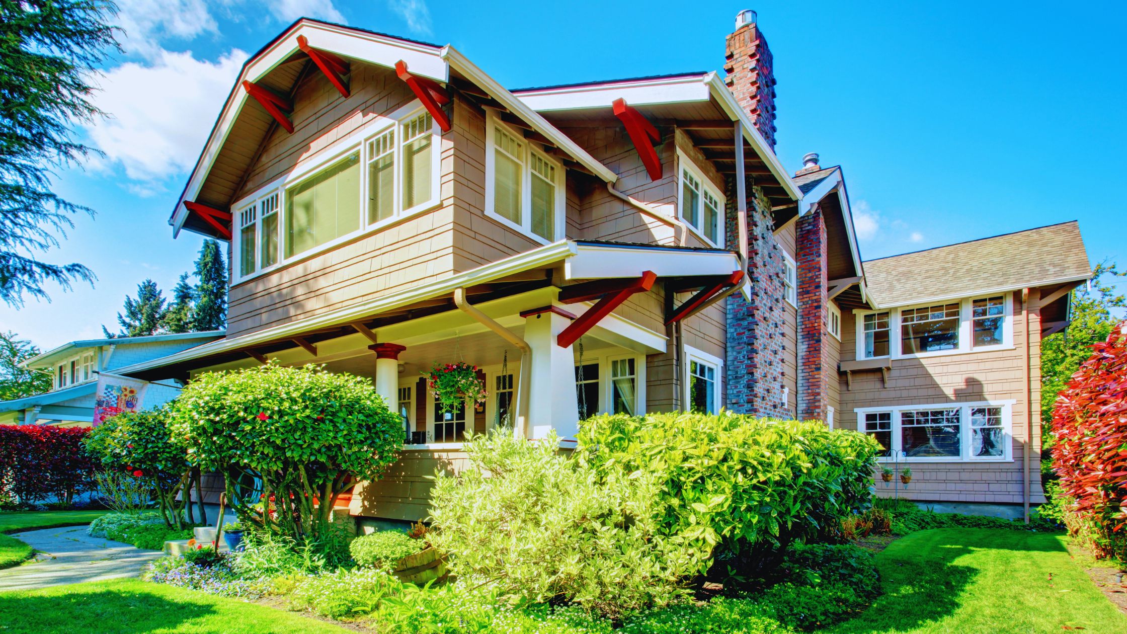 "A modern suburban home with a spacious driveway and double garage, set against a vibrant sunset sky, featuring well-maintained landscaping and a cozy porch light illuminating the entryway.