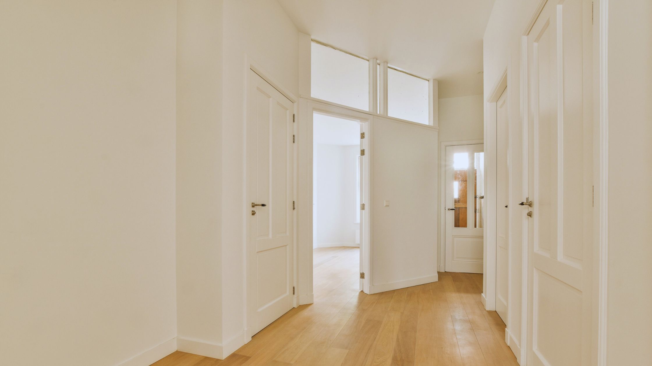 "A modern suburban home with a spacious driveway and double garage, set against a vibrant sunset sky, featuring well-maintained landscaping and a cozy porch light illuminating the entryway.