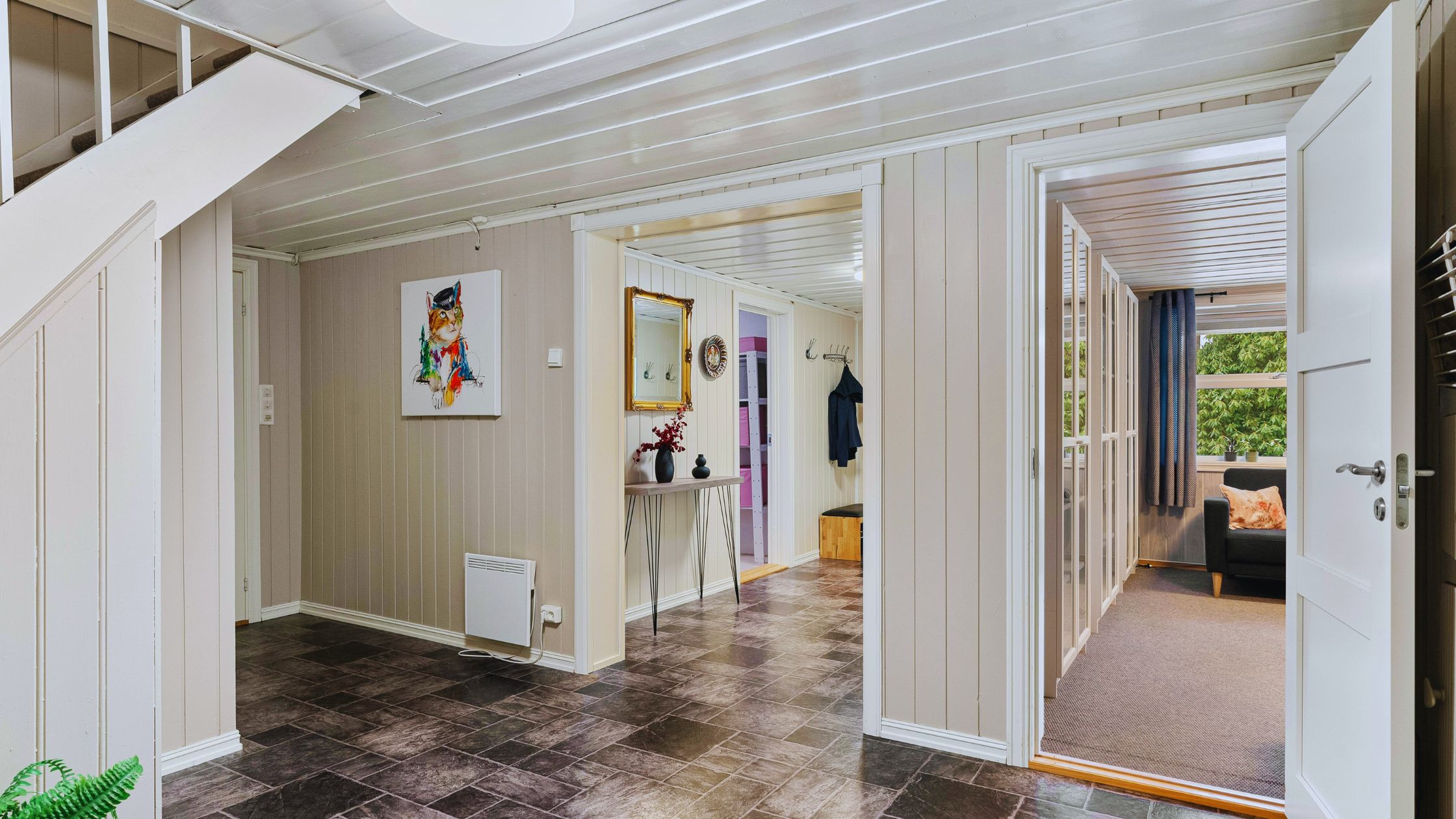 "A modern suburban home with a spacious driveway and double garage, set against a vibrant sunset sky, featuring well-maintained landscaping and a cozy porch light illuminating the entryway.
