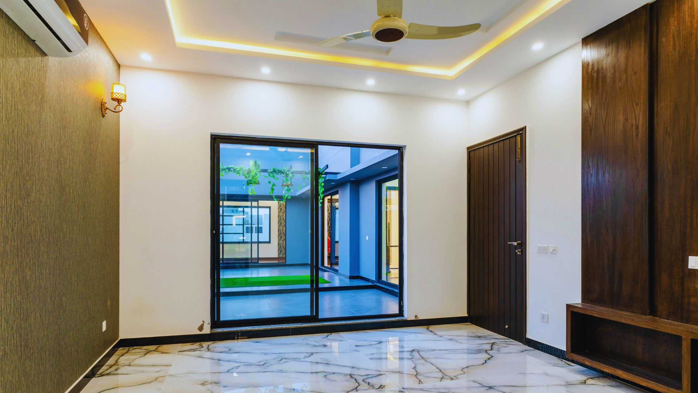 "A modern suburban home with a spacious driveway and double garage, set against a vibrant sunset sky, featuring well-maintained landscaping and a cozy porch light illuminating the entryway.