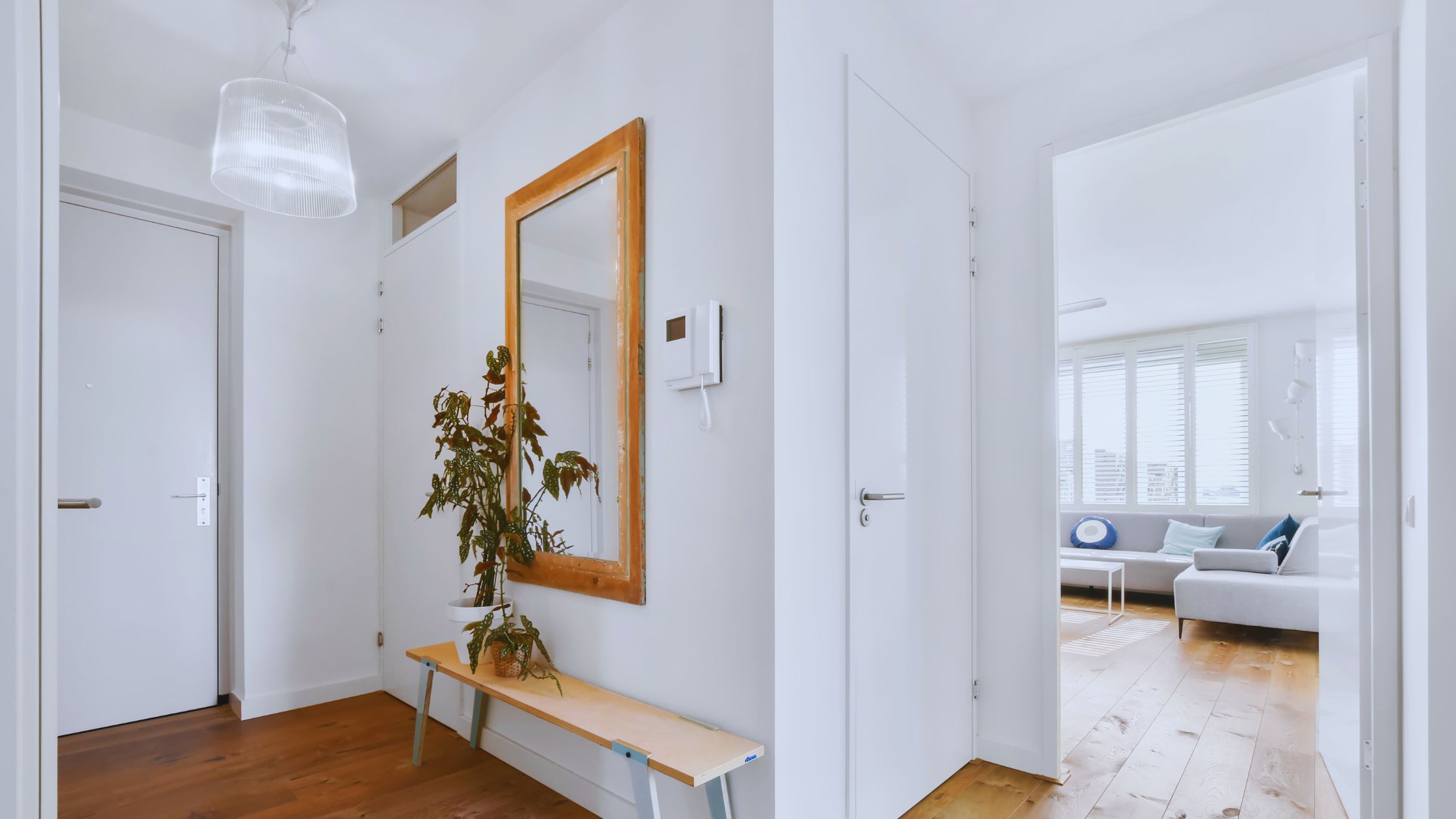 "A modern suburban home with a spacious driveway and double garage, set against a vibrant sunset sky, featuring well-maintained landscaping and a cozy porch light illuminating the entryway.