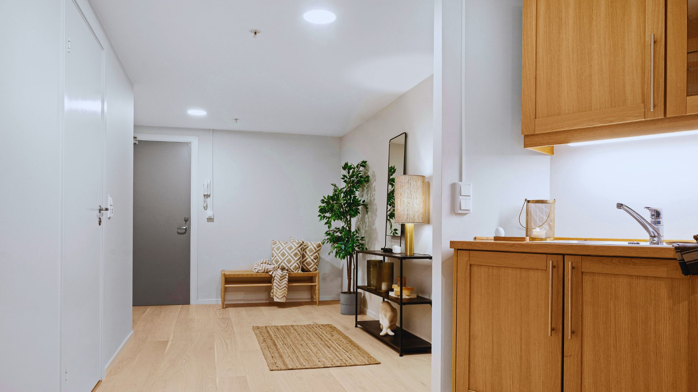 "A modern suburban home with a spacious driveway and double garage, set against a vibrant sunset sky, featuring well-maintained landscaping and a cozy porch light illuminating the entryway.