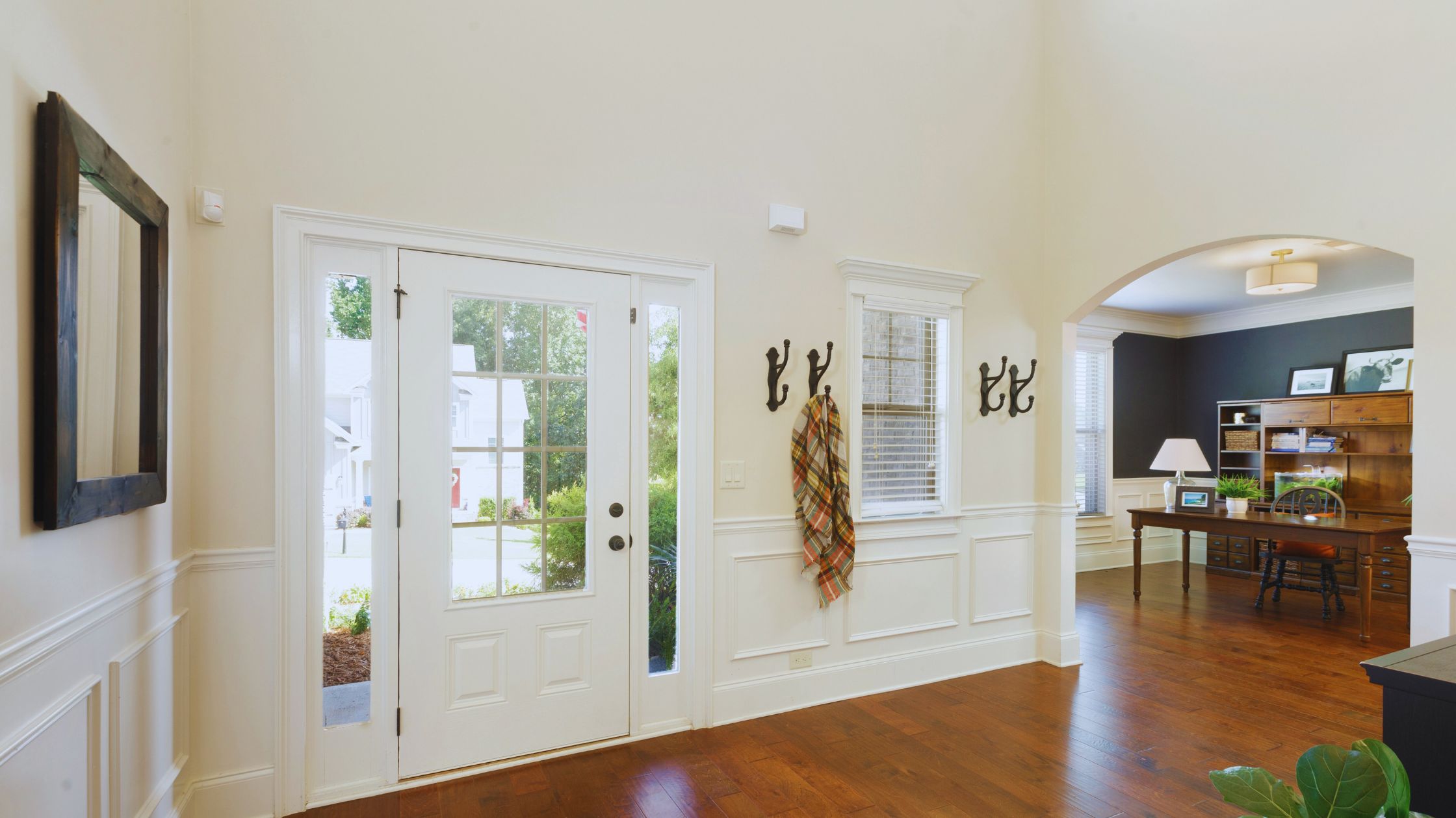 "A modern suburban home with a spacious driveway and double garage, set against a vibrant sunset sky, featuring well-maintained landscaping and a cozy porch light illuminating the entryway.