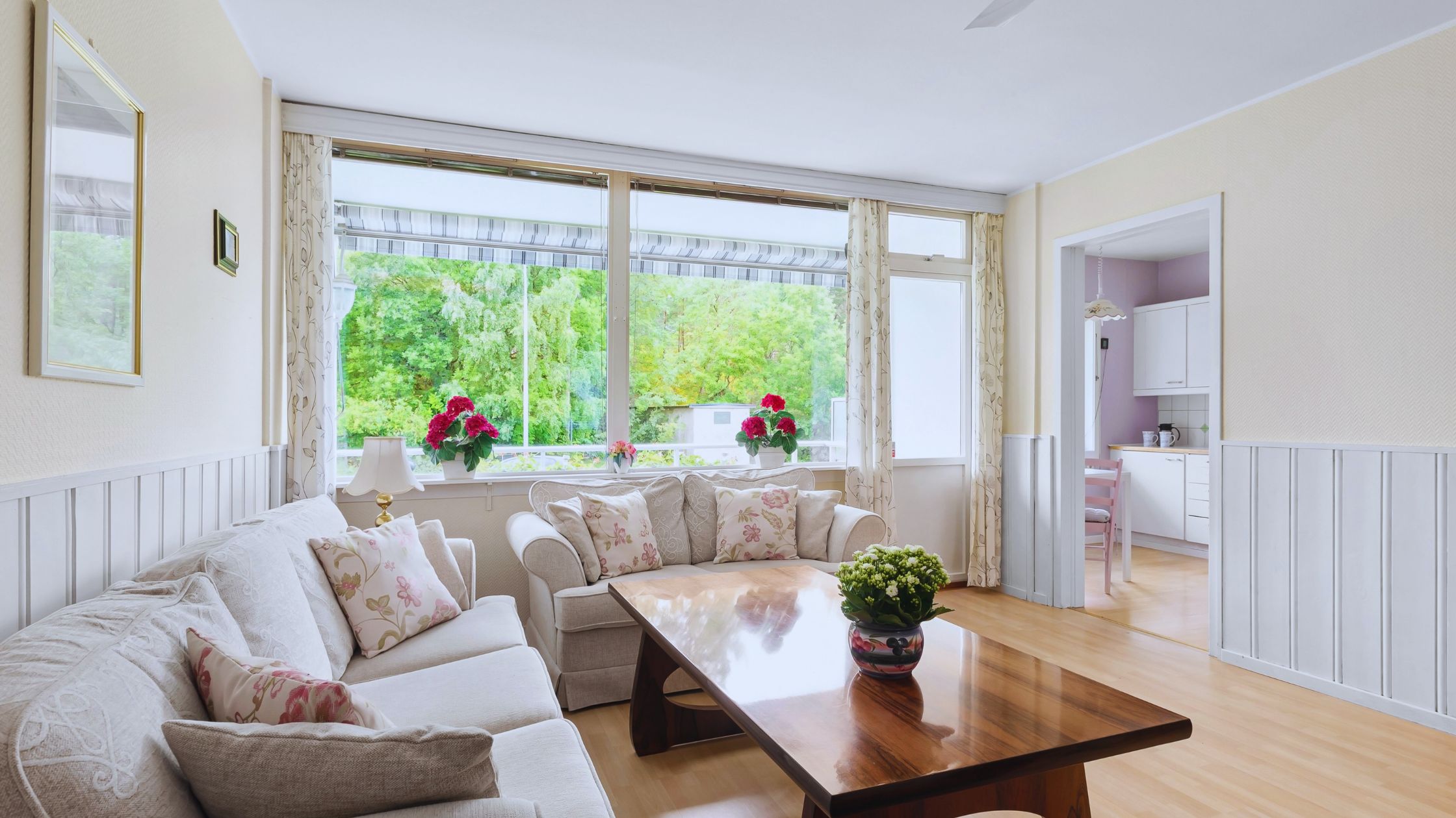 "A modern suburban home with a spacious driveway and double garage, set against a vibrant sunset sky, featuring well-maintained landscaping and a cozy porch light illuminating the entryway.