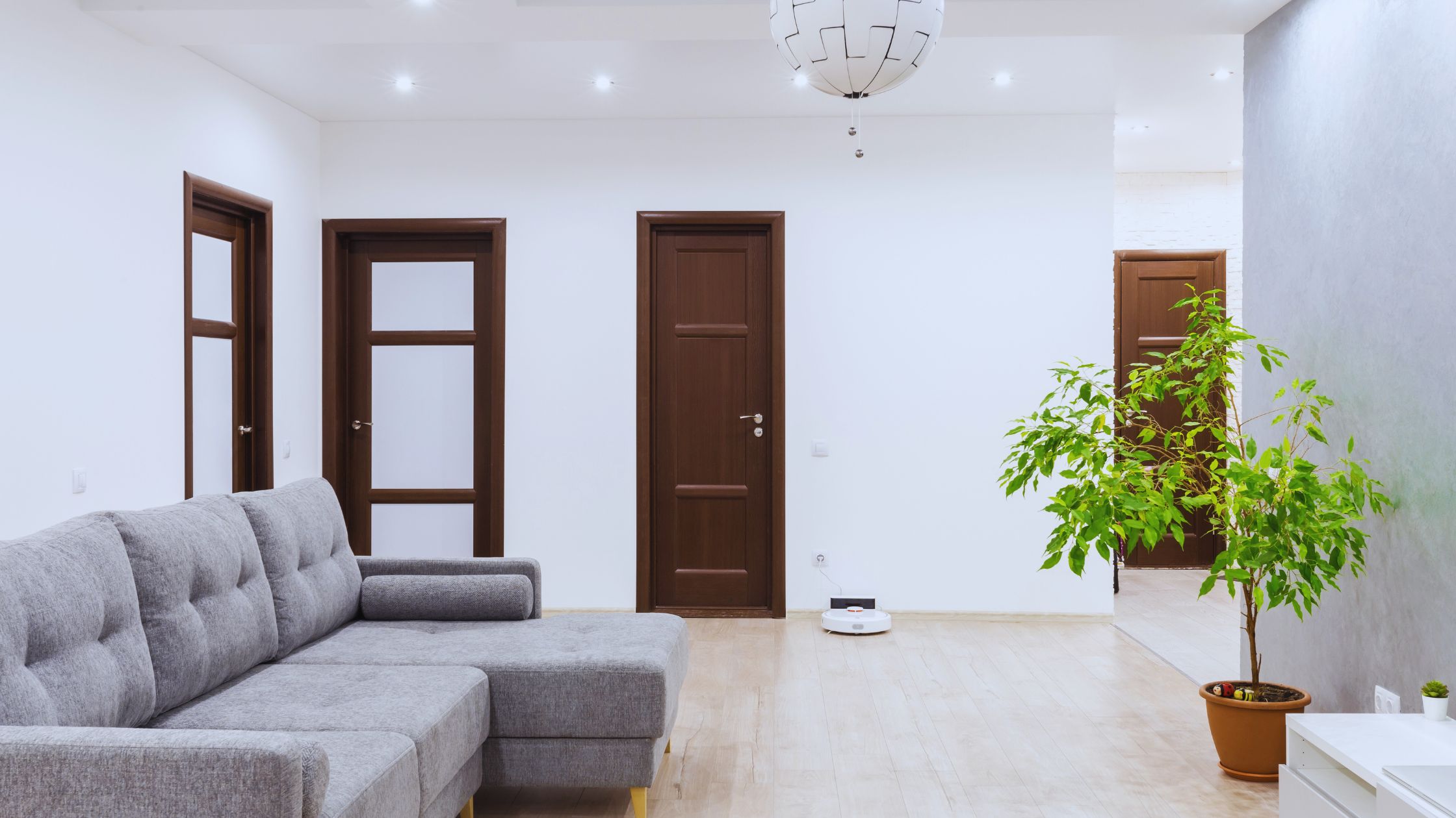 "A modern suburban home with a spacious driveway and double garage, set against a vibrant sunset sky, featuring well-maintained landscaping and a cozy porch light illuminating the entryway.