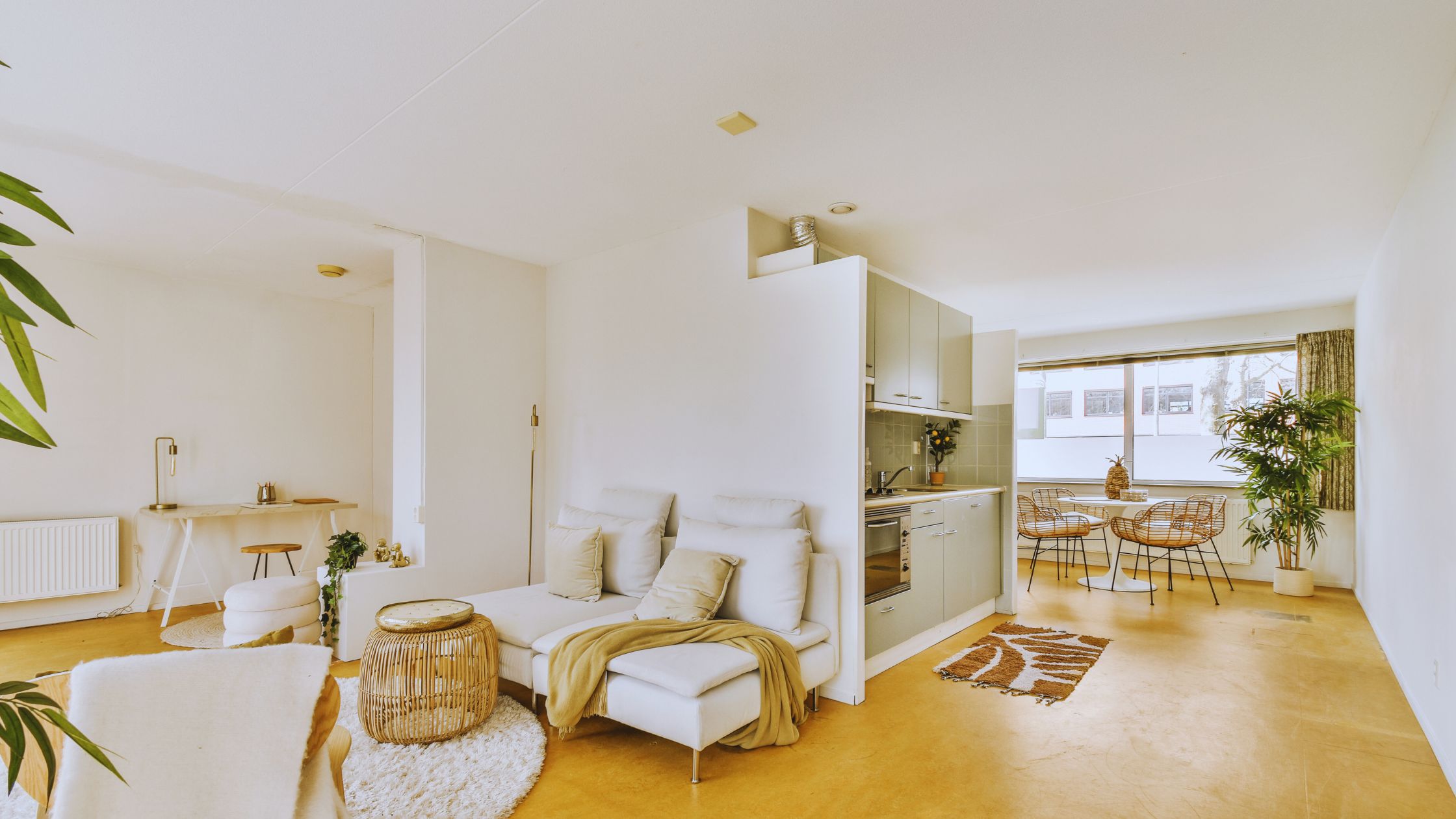 "A modern suburban home with a spacious driveway and double garage, set against a vibrant sunset sky, featuring well-maintained landscaping and a cozy porch light illuminating the entryway.