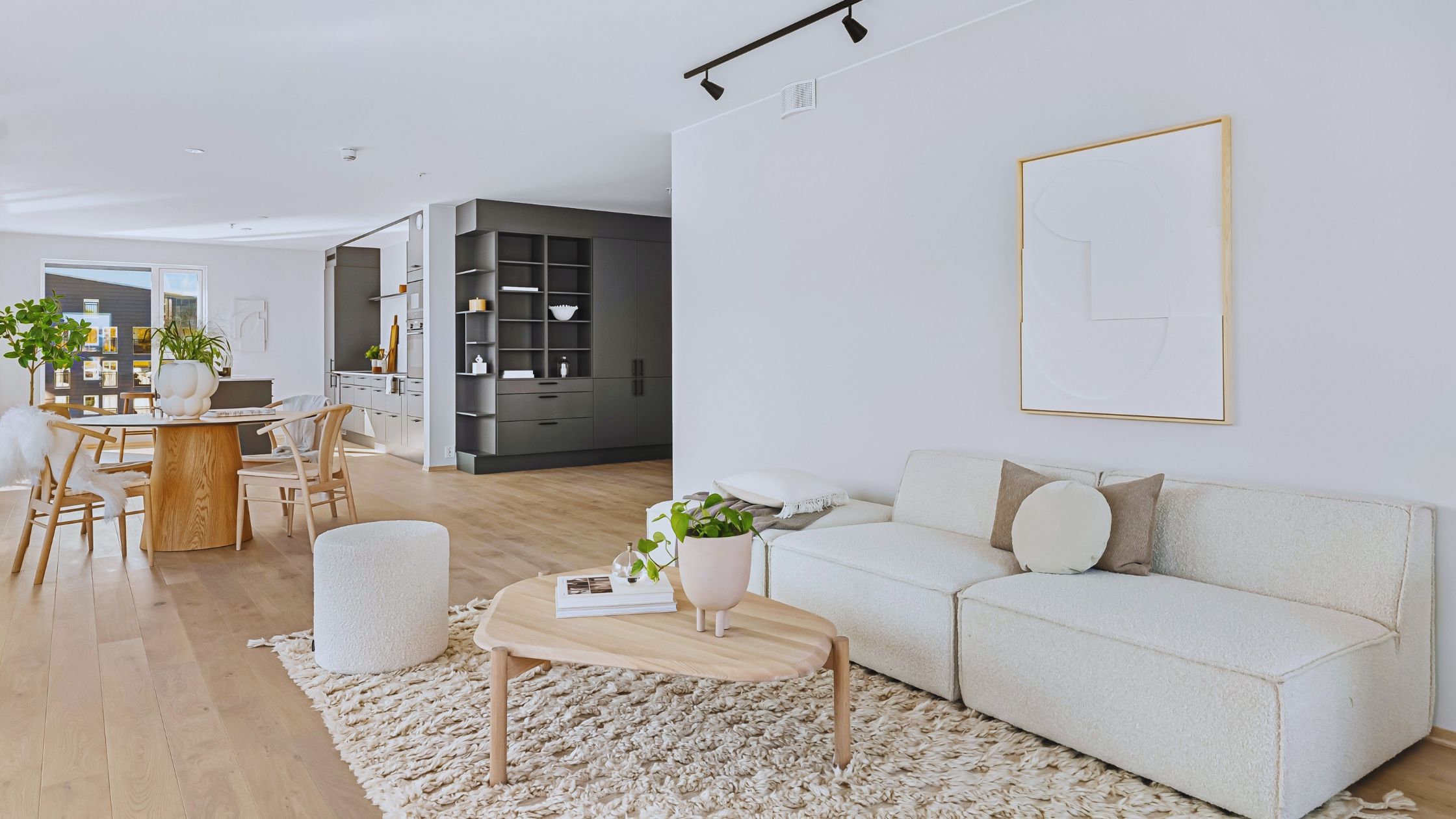 "A modern suburban home with a spacious driveway and double garage, set against a vibrant sunset sky, featuring well-maintained landscaping and a cozy porch light illuminating the entryway.