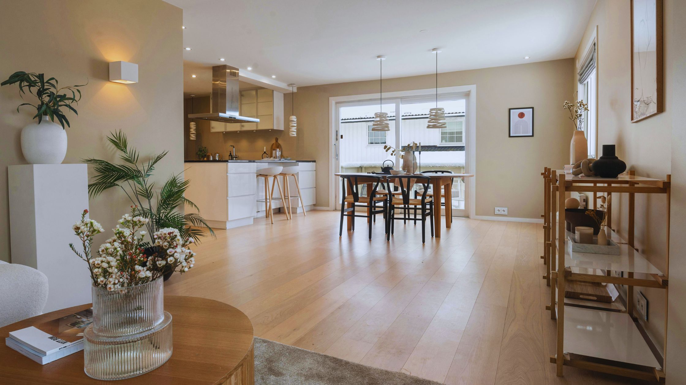 "A modern suburban home with a spacious driveway and double garage, set against a vibrant sunset sky, featuring well-maintained landscaping and a cozy porch light illuminating the entryway.