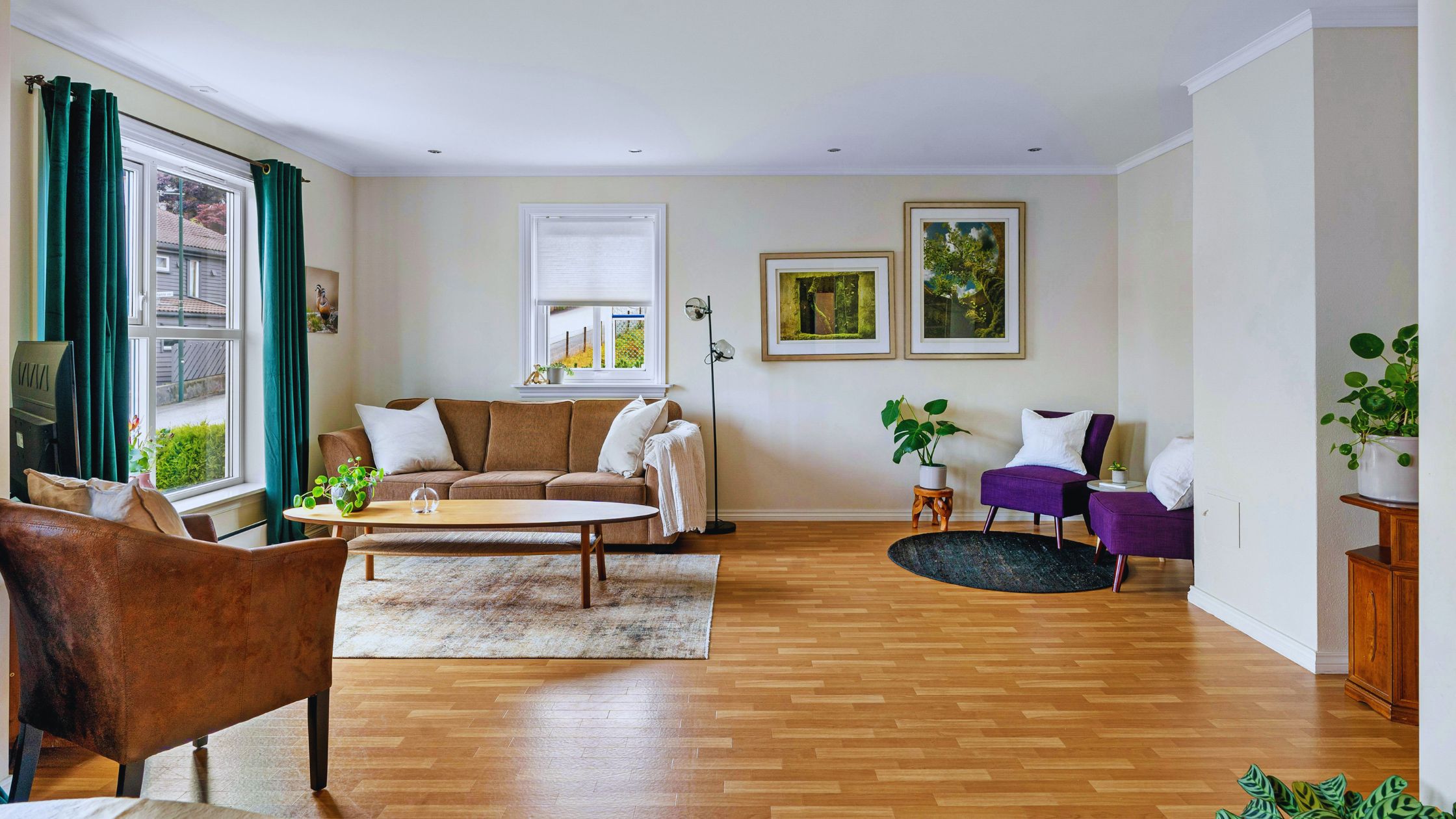 "A modern suburban home with a spacious driveway and double garage, set against a vibrant sunset sky, featuring well-maintained landscaping and a cozy porch light illuminating the entryway.
