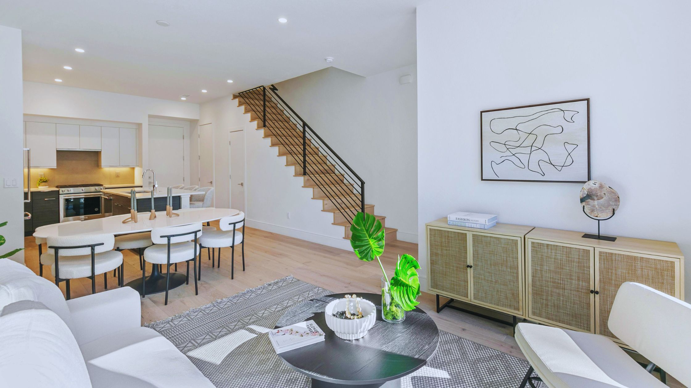 "A modern suburban home with a spacious driveway and double garage, set against a vibrant sunset sky, featuring well-maintained landscaping and a cozy porch light illuminating the entryway.