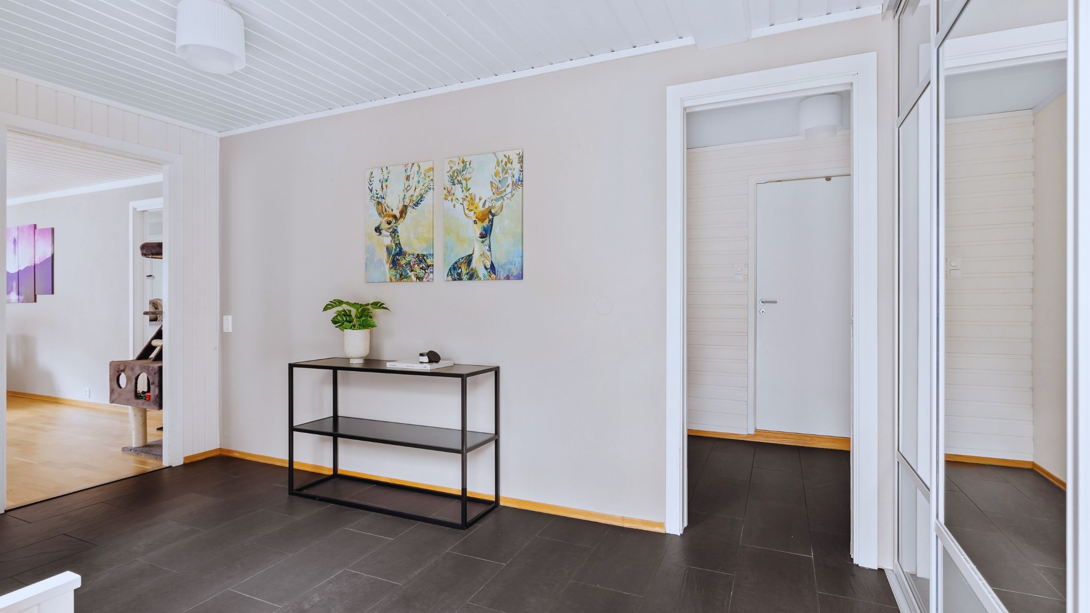 "A modern suburban home with a spacious driveway and double garage, set against a vibrant sunset sky, featuring well-maintained landscaping and a cozy porch light illuminating the entryway.