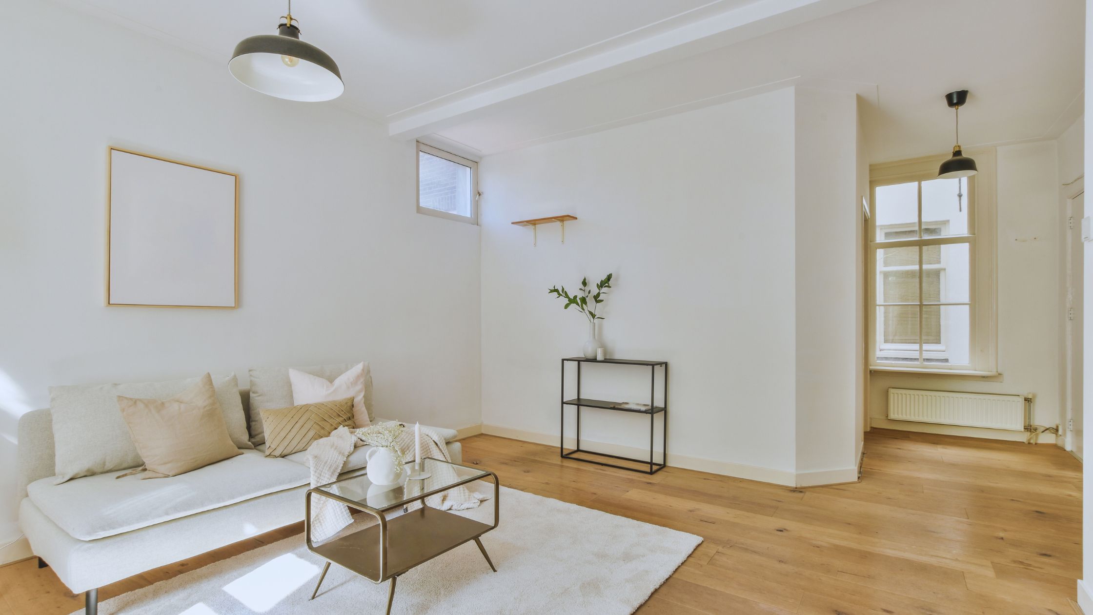 "A modern suburban home with a spacious driveway and double garage, set against a vibrant sunset sky, featuring well-maintained landscaping and a cozy porch light illuminating the entryway.
