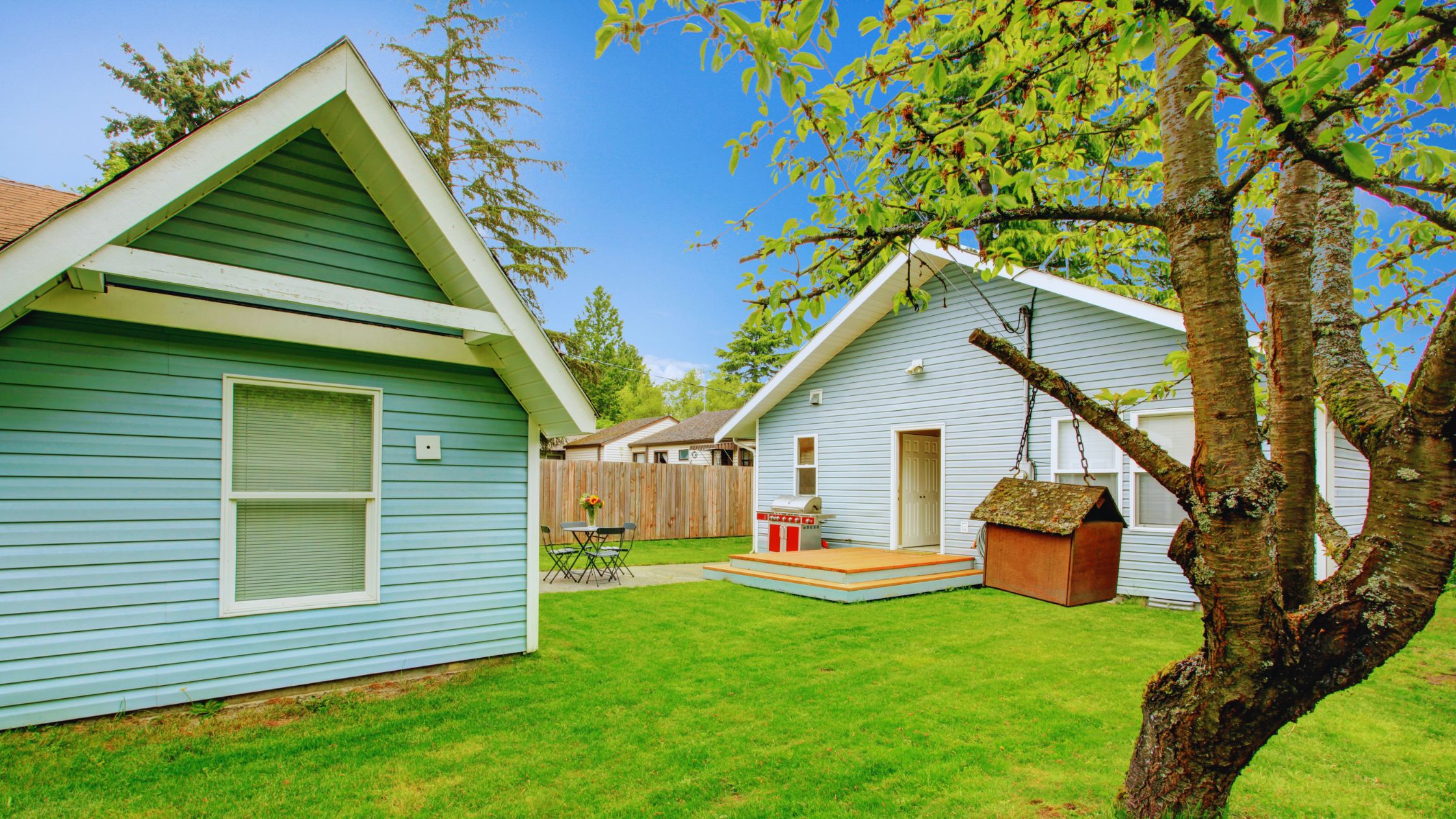 "A modern suburban home with a spacious driveway and double garage, set against a vibrant sunset sky, featuring well-maintained landscaping and a cozy porch light illuminating the entryway.