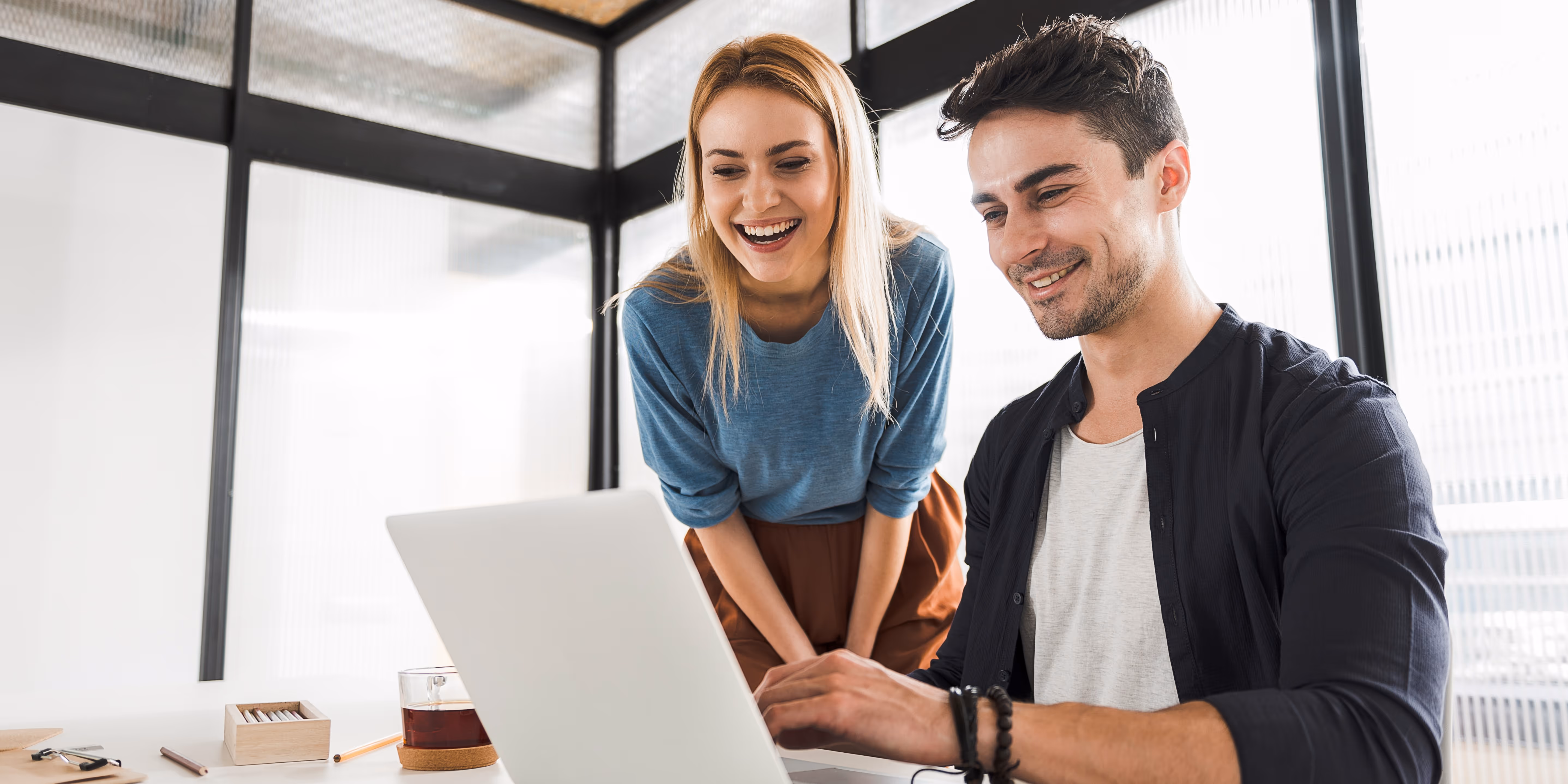 First Technology man and woman on laptop