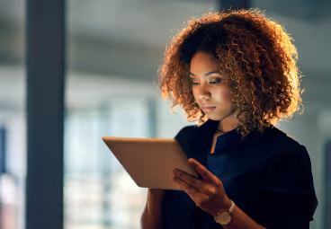 First Technology african woman reading tablet