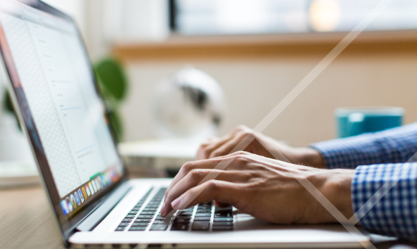 Close-up of hands typing on a laptop - First Technology Cyber Security